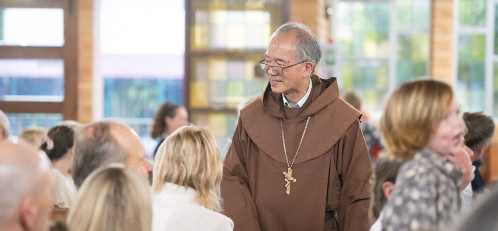 Bishop Greg walking through church